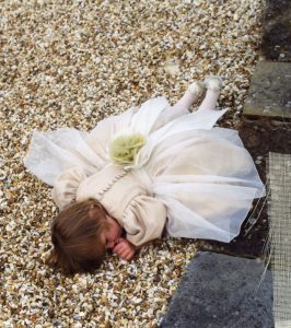 Bridesmaid in fitted bodice dress with puff sleeves and net overskirt by Joanna Bell